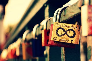 Image by Missy from Pixabay of a love lock or padlock at a castle with the infinity sign drawn with black marker and the German words “ich liebe dich” meaning I love you” in English