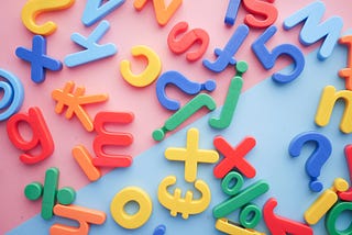 A collection of colourful fridge magnet letters and numbers.