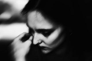 Blurry black and white photo of a white woman crying