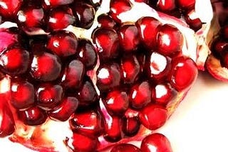 glistening red pomegranate seeds