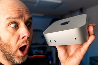 Mark Ellis holding up and gawping at the M4 Mac Mini