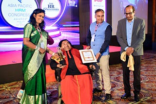 Sai Kaustuv Dasgupta pictured received award with three other people presenting. Courtesy of Sai