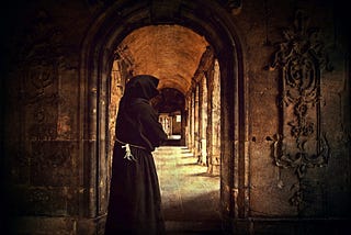 Monk standing in a cloister doorway