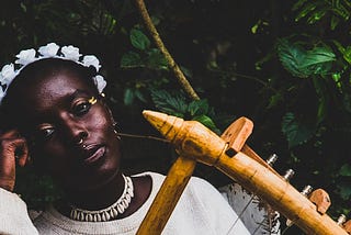 Akoth Jumadi poses with a nyatiti, which is a traditional string instrument from the Luo community in Africa.