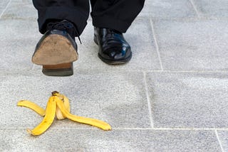 Person about to step and trip on a banana peel.