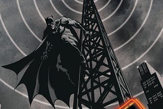 Batman hangs from the side of an old-time radio tower, all in blacks, whites, and greys. Classic radio waves eminate from the tower.