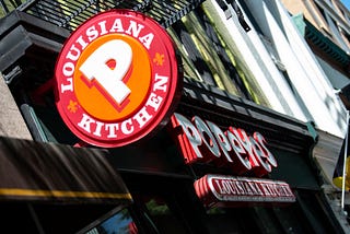 A photo of a Popeyes store front and logo.