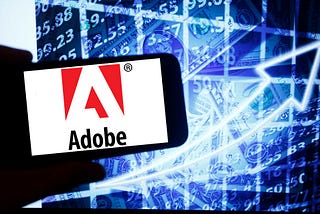 A photo of Adobe’s logo on a smartphone.