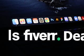 Image of MacBook laptop open with app bar visible showing Adobe Photoshop and Adobe Illustrator icons with words “Is Fiverr Dead?” overlay