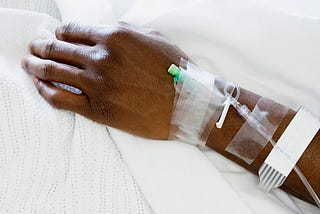Closeup of hand of a patient at hospital with IV drip.