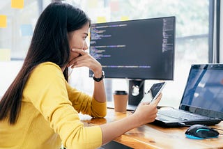 A woman looks at her laptop deep in thought, looking at the results of a business experiment.