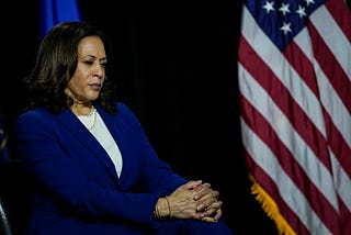 Democratic vice presidential candidate Kamala Harris sits and listen to Joe Biden’s remarks at the Alexis Dupont High School.