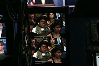 April Ryan, seen on a TV monitor, asking questions in the White House press briefing room.