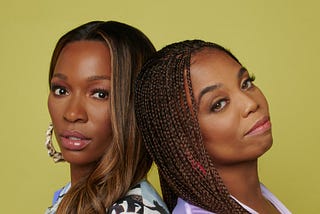 Closeup portrait photo of Jemele Hill and Cari Champion standing back-to-back.