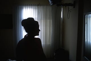 Silhouette of a woman in a room.