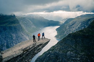 People On Snowcapped Mountains Against Sky