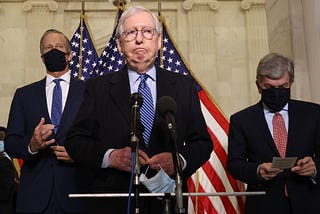 Mitch McConnell speaking into a mic.