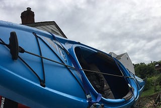 A kayak on top of a car.