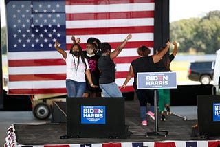 A group of AKA members dance onstage at a Biden/Harris event.