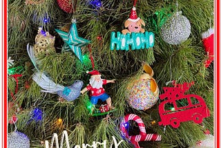 A close-up of a Christmas tree with many colourful decorations. The words, Merry Christmas’ are superimposed across the bottom.