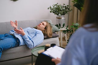 Psychologist against patient on couch
