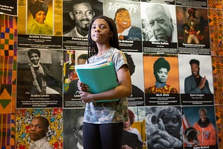 A seventh grader walks by a Black History Month display at Sutton Middle School on her way to class.