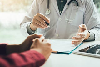 A doctor talking to the patient about their diagnosis.