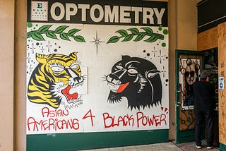 Mural: A tiger and a panther, branches, and sparkles above the text “Asian Americans 4 Black power.”