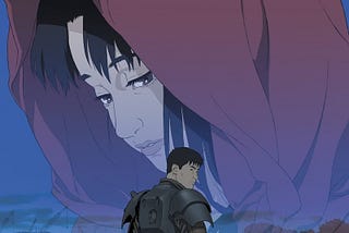 A poster for Jin-Roh: The Wolf Brigade features Kazuki Fuse — a soldier with short black hair, wearing a black, semi-dystopian armored uniform minus helmet, holding a machine gun in one hand and his helmet in the other — turned three-quarters away. The background looks like a wasteland with piles of rubble. A  transparent image of Kei Amemiya — a young woman with dark hair wearing a red jacket with a hood — takes up the middle ground, with her face taking up the top portion.