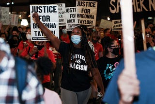 Black woman protesting the grand jury decision in Breonna Taylor’s case.