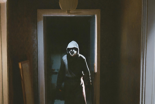 Intruder in a dark hallway.