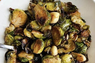 A plate of roasted Brussels sprouts with garlic