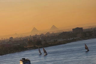 Pyramids of Giza and the River Nile with sailboats