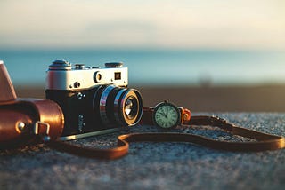 A photo of a close-up of a camera on a rock.