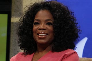 Oprah Winfrey sits on the set of her daytime talk show.