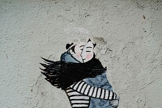 Two people hugging each other
