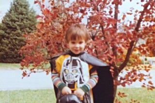 Young girl in vintage Darth Vader costume