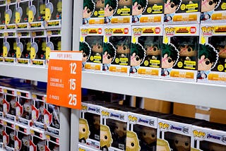 Boxes of Funko Pop figurines on shelves.