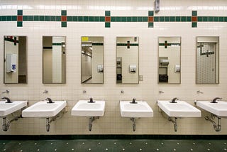 A view of the sinks and mirrors in a public bathroom.