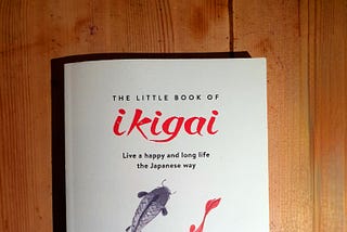 A copy of the book The Little Book of Ikigai on a simple wooden background. Edward Breen, 2023.