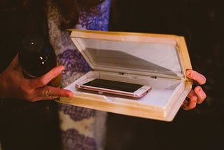 A photo of a iPhone being put away in a case.