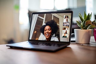 Businesswoman having a video call meeting with her team.