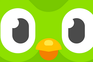 Closeup of the green owl icon of Duolingo.