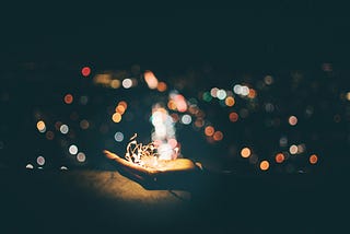 A person’s hand with stringed lights