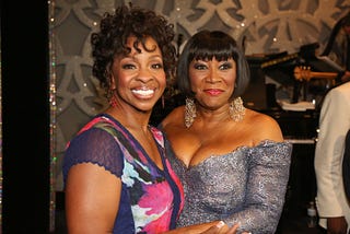 Gladys Knight and Patti Labelle pose for a photo together at an event.