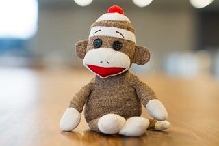 a quirky and lovable monkey made of socks with earnest looking eyebrows