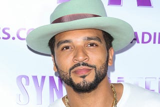 A closeup photo of Jemel McWilliams at an event in 2017. He is wearing a hat.