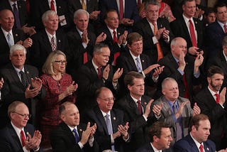 Lawmakers watch the State of the Union address in the chamber of the U.S. House of Representatives at the Capitol Building