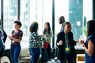A group of individuals networking with each other at an event.
