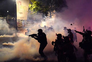 Federal officers deploy tear gas at protestors in front of the Mark O. Hatfield courthouse in Portland, Oregon.
